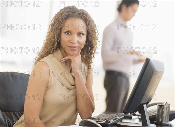 Portrait of business woman using computer.