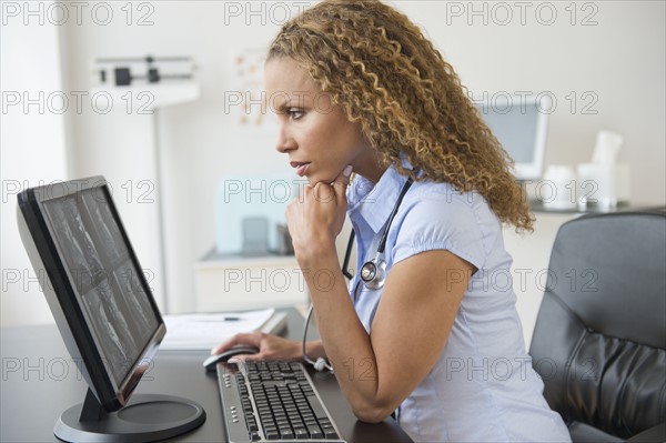 Doctor looking at computer.