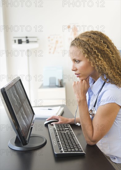 Doctor looking at computer.