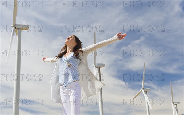 Young woman at wind farm.