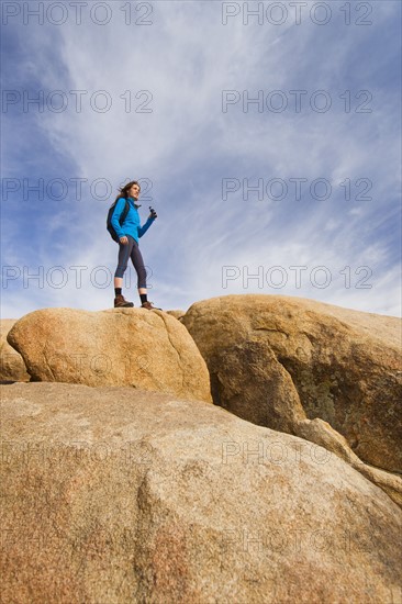 USA, California, Joshua Tree National Park, Female hiker on rocks.