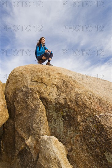 USA, California, Joshua Tree National Park, Female hiker on rocks.