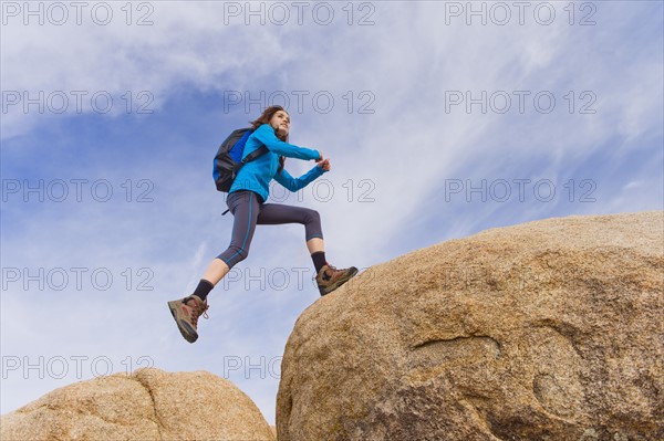 USA, California, Joshua Tree National Park, Female hiker on rocks.