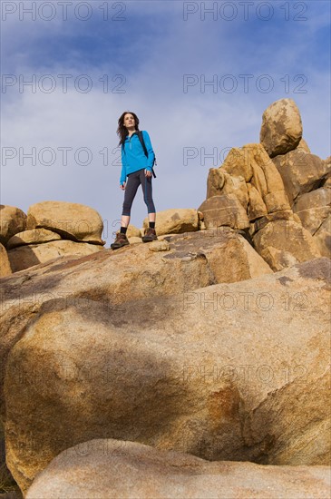 USA, California, Joshua Tree National Park, Female hiker on rocks.