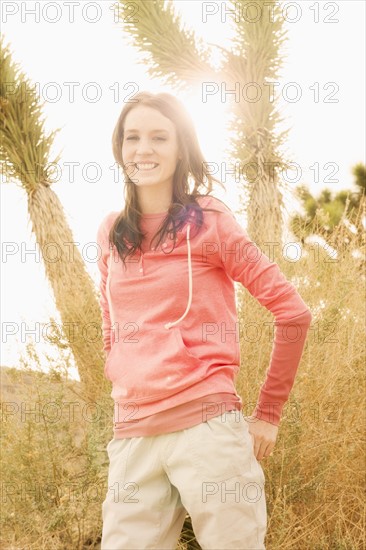 USA, California, Joshua Tree National Park, Portrait of young woman in desert.