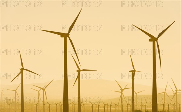 USA, California, Palm Springs, Wind turbine against sunset sky.