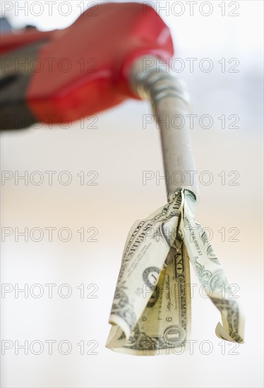 Fuel nozzle with dollar bill.