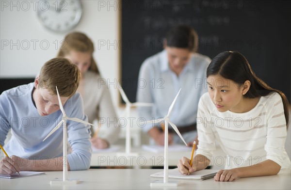 Students (14-19) examining wind turbines.