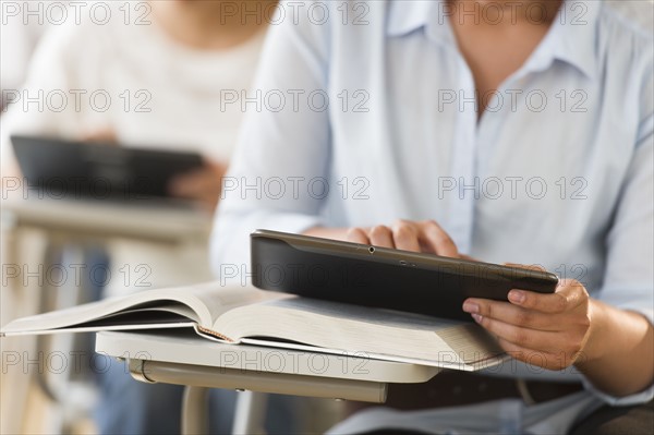 Students (14-19) using digital tablets.