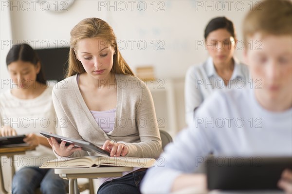 Students (14-19) using digital tablets at school.