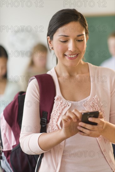 Female student texting on phone.