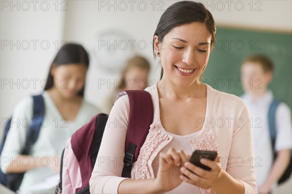 Female student texting on phone.