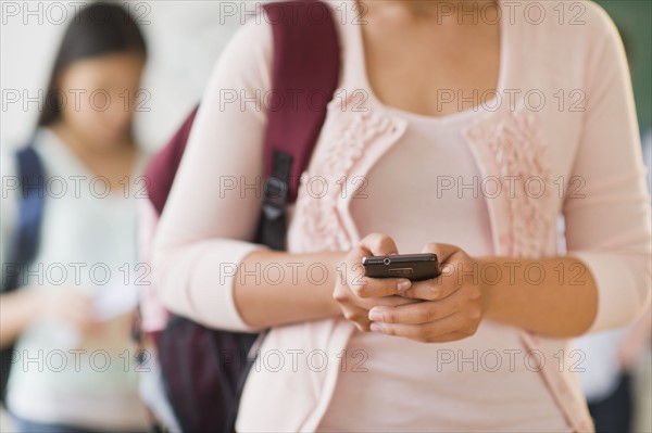 Female student texting on phone.