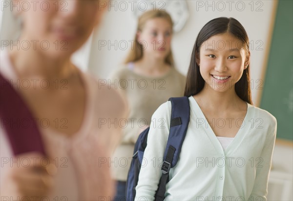 Students (14-19) in classroom.