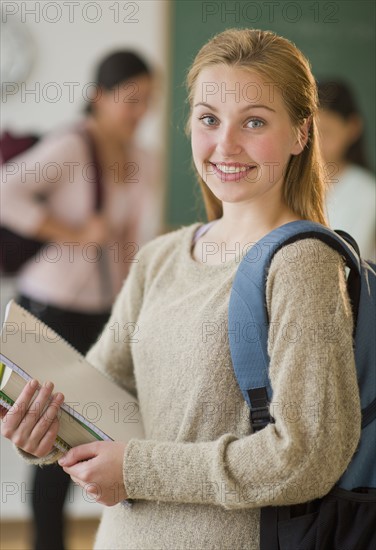 Portrait of female student (16-17) in classroom.