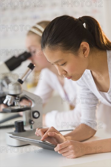 Students (14-17) using tablet pc in chemistry lab.