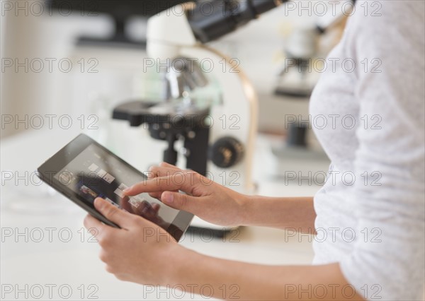 Student (14-15) using tablet pc in chemistry lab.