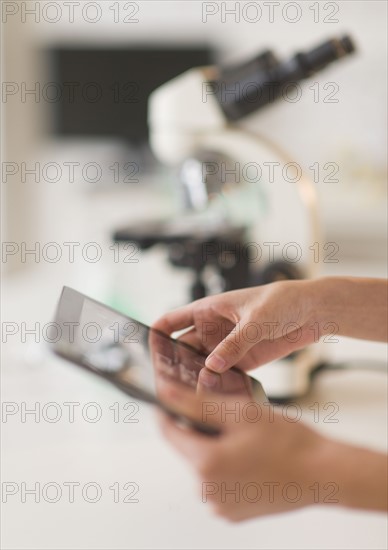 Student (14-15) using tablet pc in chemistry lab.
