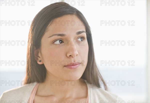 Portrait of young woman thinking.