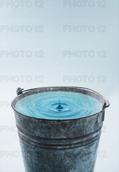 Drop falling into water in bucket.