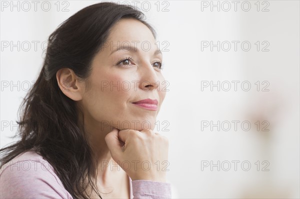 Woman with hand on chin.