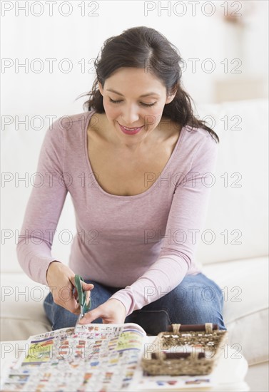 Woman cutting out coupons.