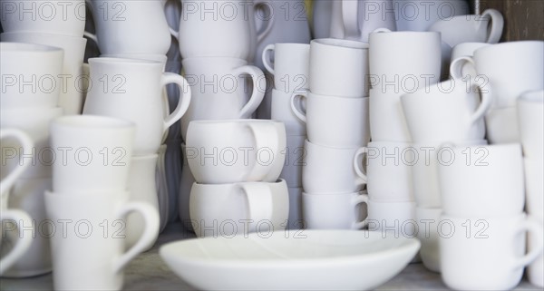 Stacked unfinished white pottery.