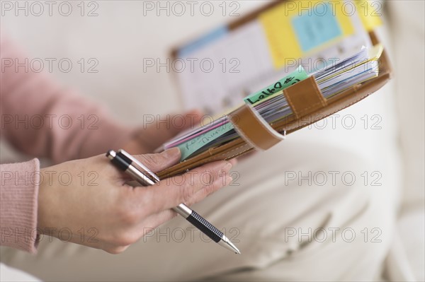 Hands holding personal organizer.