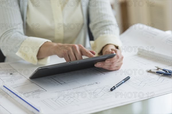 Architect working on digital tablet.