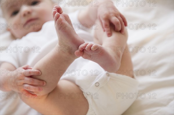 Baby boy (2-5) touching legs. 
Photo: Jamie Grill