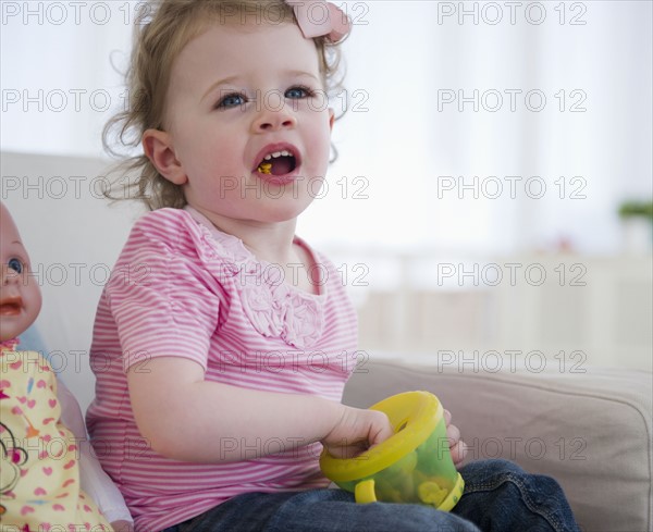 Girl (2-3) eating snacks. 
Photo : Jamie Grill