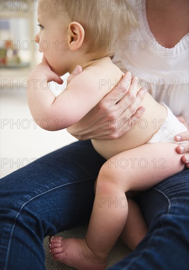 Mother holding son (6-11 months) . 
Photo: Jamie Grill