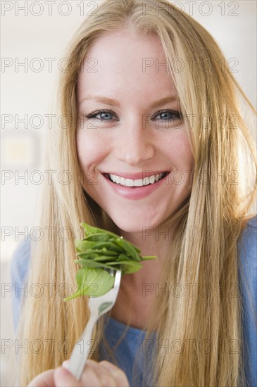 Portrait of woman eating salad. 
Photo : Jamie Grill