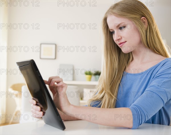 Woman using digital tablet. 
Photo : Jamie Grill