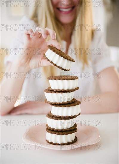 Woman enjoying ice cream sandwich. 
Photo : Jamie Grill