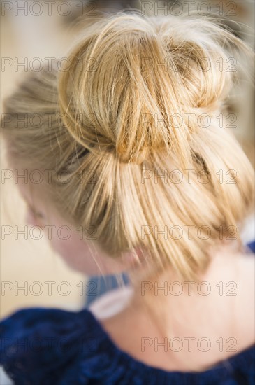 Elevated view of woman with hair bun. 
Photo : Jamie Grill