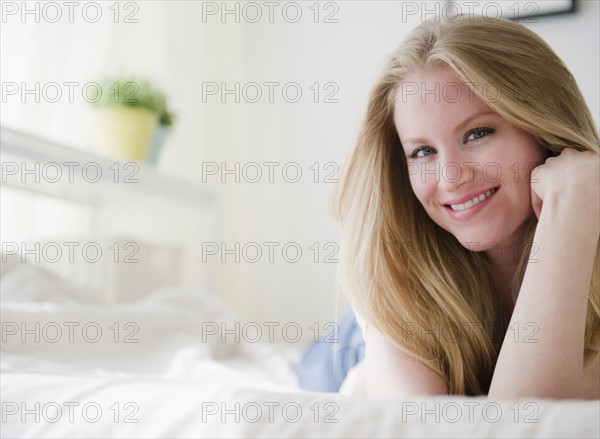 Woman relaxing on bed. 
Photo : Jamie Grill