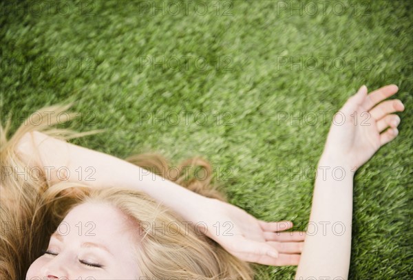 Woman lying on grass. 
Photo : Jamie Grill