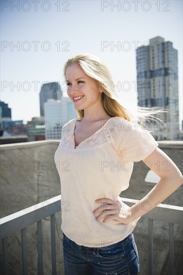 Woman standing on balcony. 
Photo : Jamie Grill