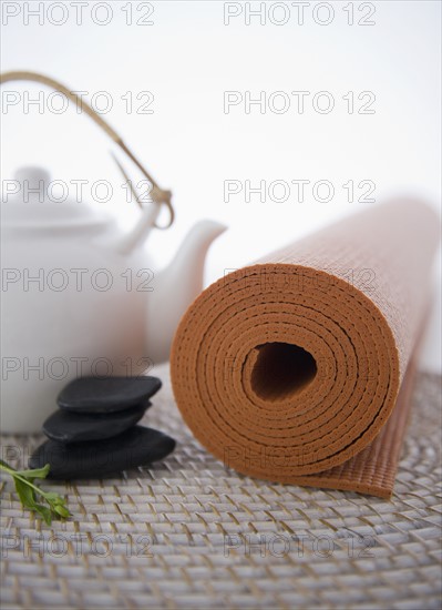 Still life with teapot, stones and yoga mat. 
Photo : Jamie Grill