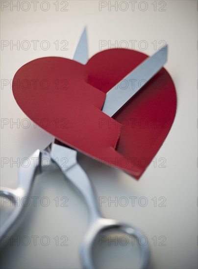 Scissors cutting paper heart. 
Photo : Jamie Grill