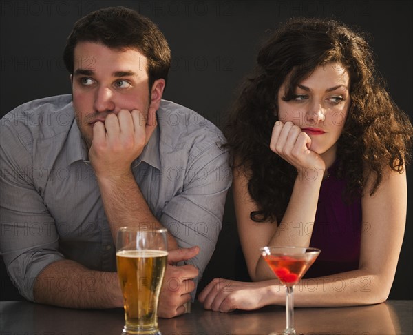 Bored couple sitting at bar counter. 
Photo: Jamie Grill