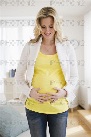 Pregnant woman touching belly. 
Photo: Jamie Grill
