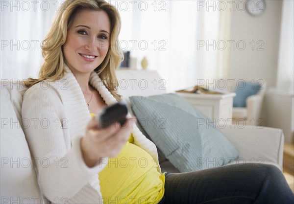 Pregnant woman watching tv. 
Photo : Jamie Grill