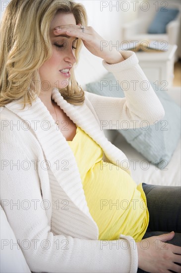 Pregnant woman with head in hands. 
Photo : Jamie Grill