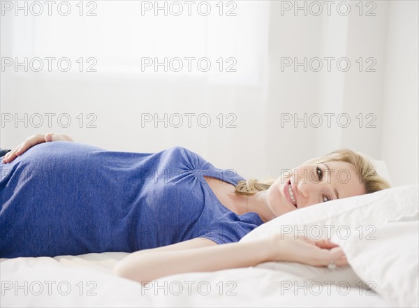 Pregnant woman lying in bed.
Photo: Jamie Grill