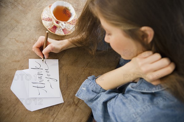 Woman writing greeting card. 
Photo: Jamie Grill