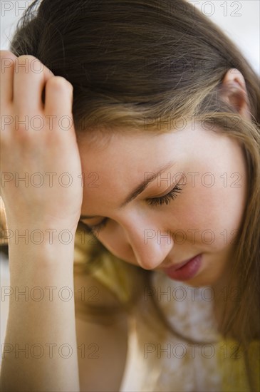 Woman with head in hands. 
Photo: Jamie Grill