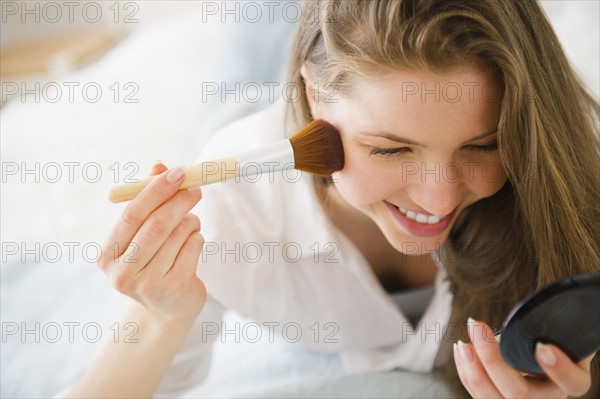 Woman applying make-up. 
Photo: Jamie Grill