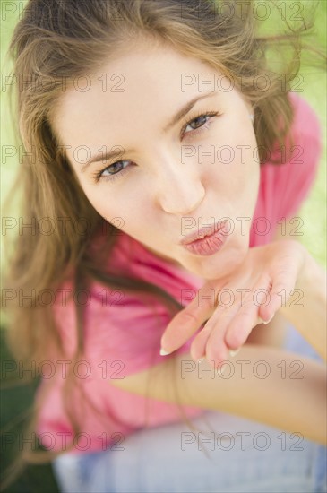 Woman blowing kiss towards camera. 
Photo : Jamie Grill